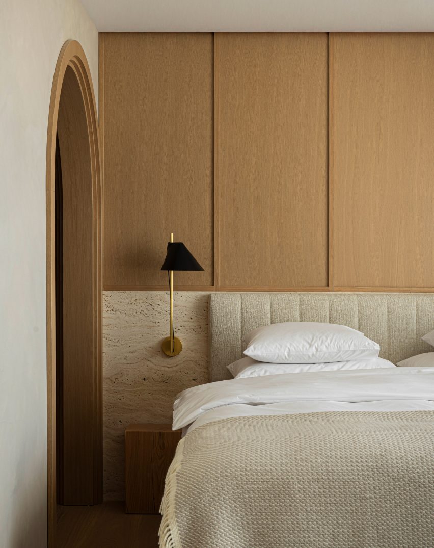 Bedroom with travertine and wood headboard