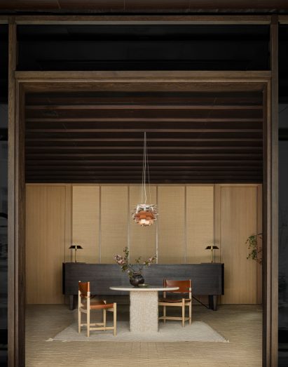 Hotel reception area featuring dark-wood Danish cabinet
