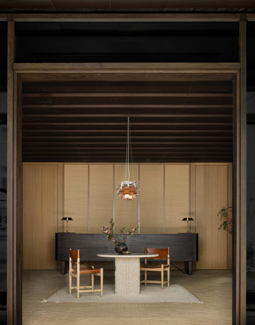 Hotel reception area featuring dark-wood Danish cabinet