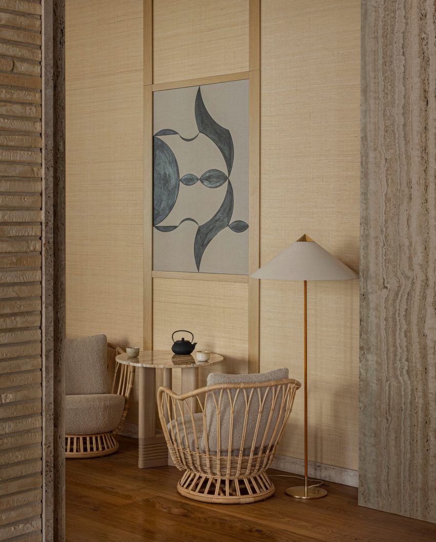 Rattan chair and black and white artwork