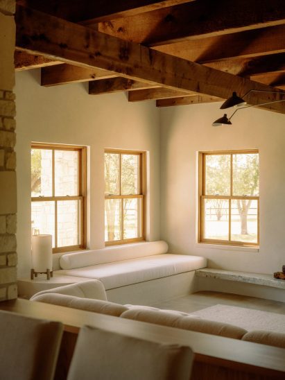 Living room with built-in window seat and exposed ceiling beams