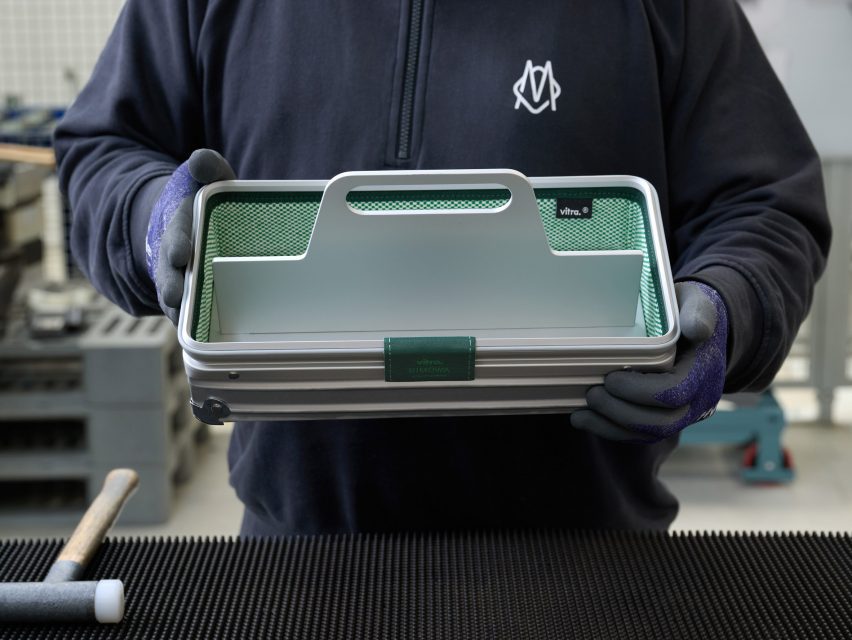A person handling a toolbox