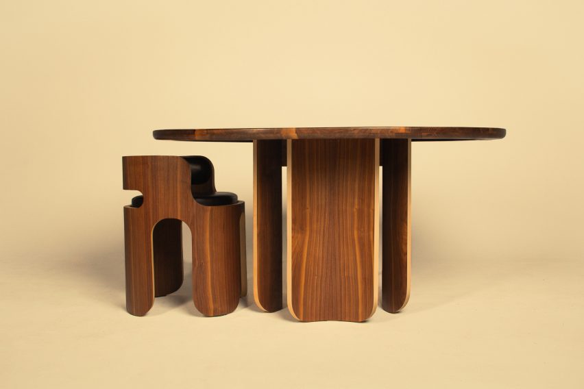 a photograph of a brown table and chair