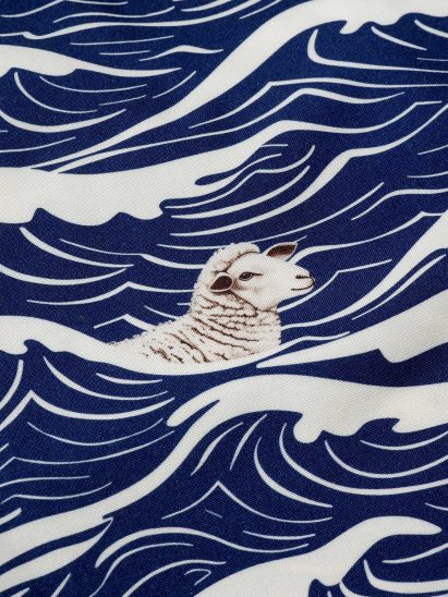 Close-up of textile showing a sheep swimming