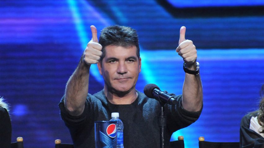 Simon Cowell holding two thumbs up