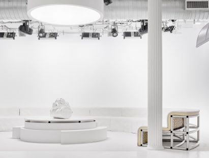TV set including a modular couch with a metal frame and white upholstered cushioning