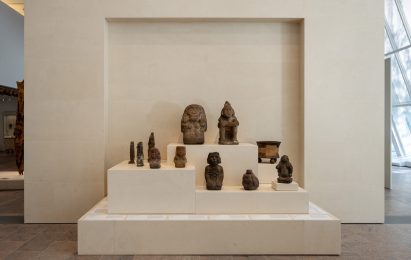 Stone sculptures from the ancient Americas displayed on stepped plinths