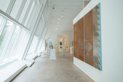 Row of large slanted windows along a gallery