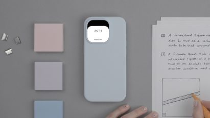 Photo of Special Projects' Aperture concept showing a smartphone turned over on a desk showing a calm, black-and-white square mini screen on its back reading 05:13 focus time