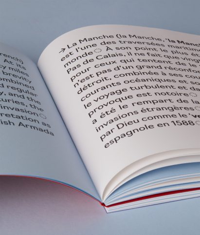 a photograph of an open book in tones of blue and white with black text on it