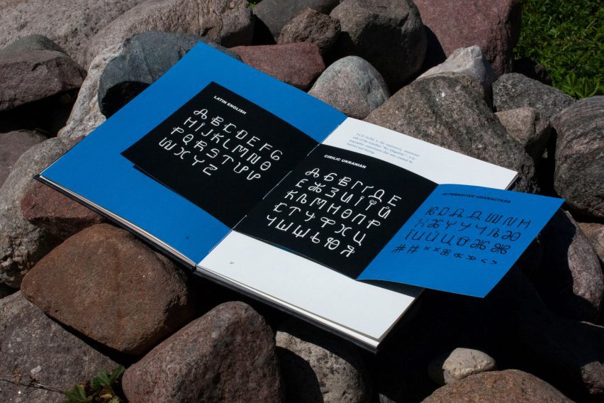 a photograph of a book in tones of blue, white and black, displaying a typeface design