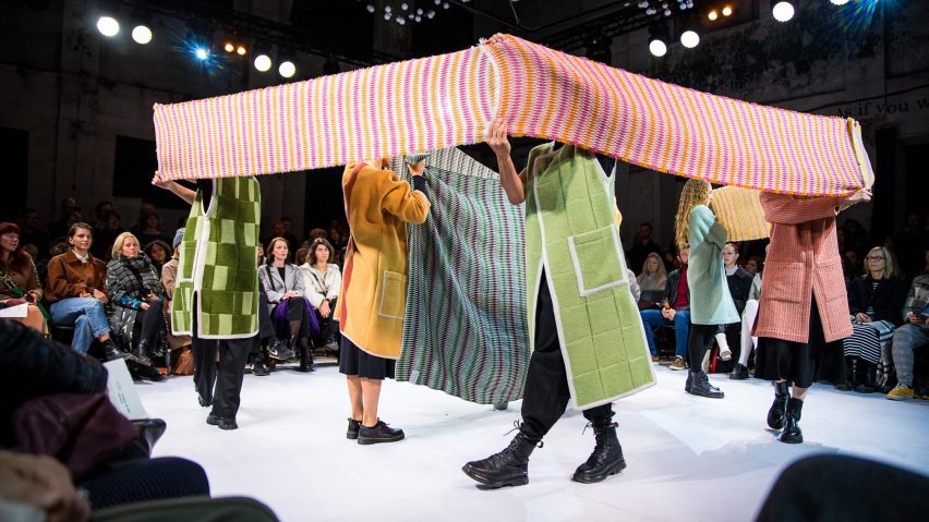Photo of people holding fabric and textiles on a catwalk