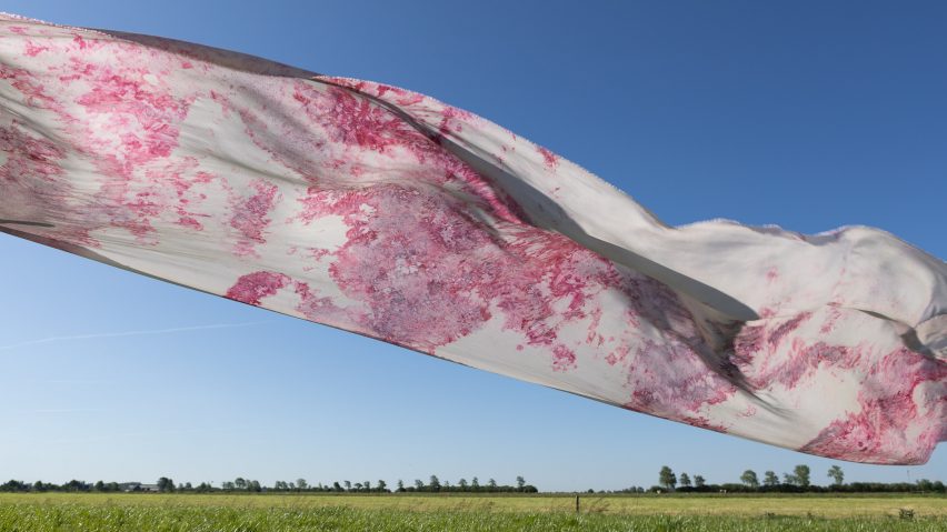 Photo of pink and white fabric flowing in the air