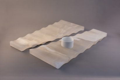 a white rectangular abstract object displayed against a grey backdrop