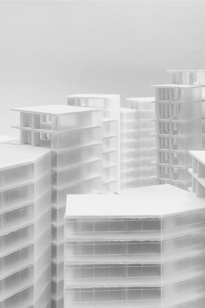 a photograph of an architectural model in tones of white and grey
