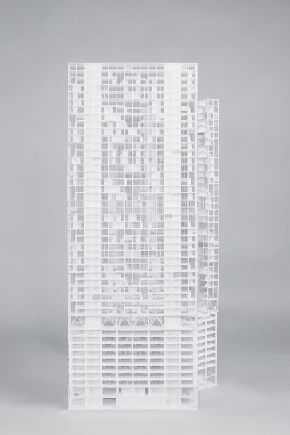a photograph of a building in tones of white against a grey backdrop