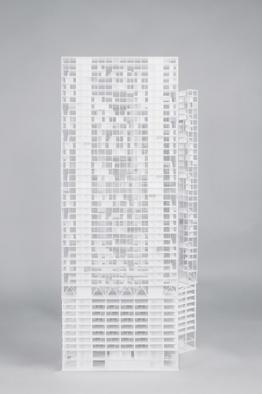 a photograph of a building in tones of white against a grey backdrop