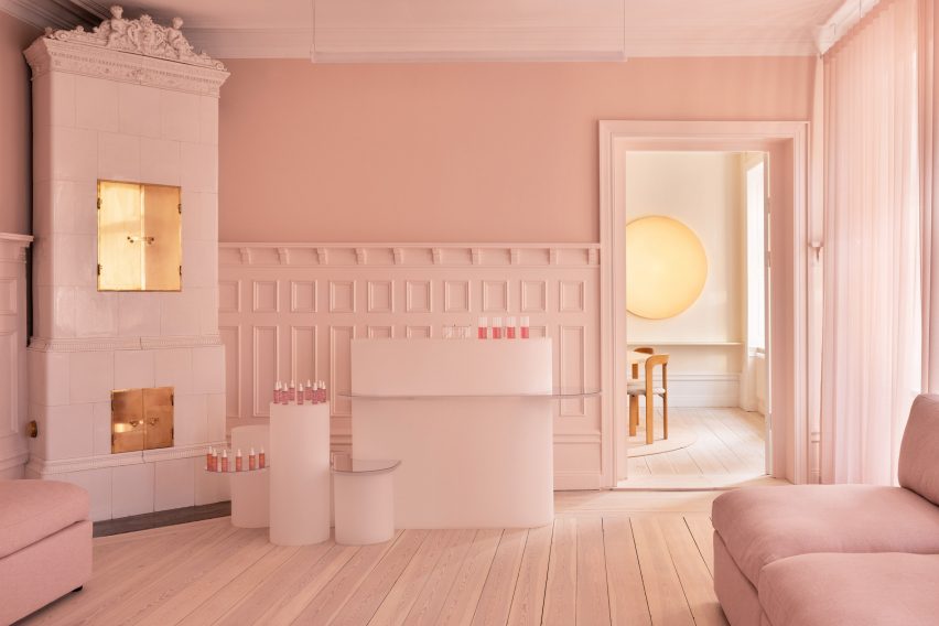 Pink walls and rounded furniture at Lumene Experience Center