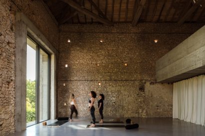People doing yoga in a barn
