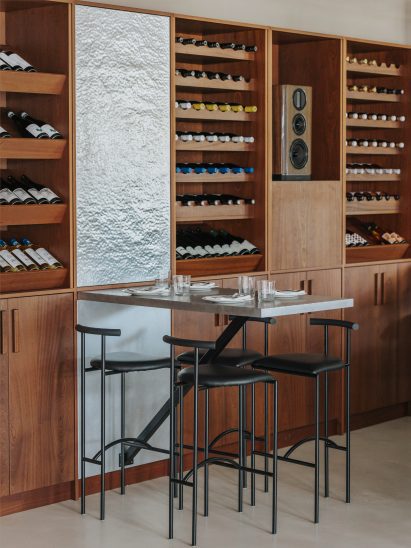 Seating area in London restaurant with black metal chairs