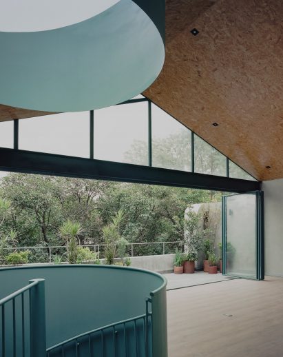 A cylindrical skylight positioned directly over a spiral staircase