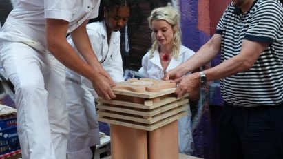 people pouring concrete into a frame
