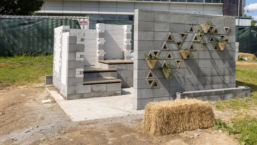 a photograph of a brick structure in a field