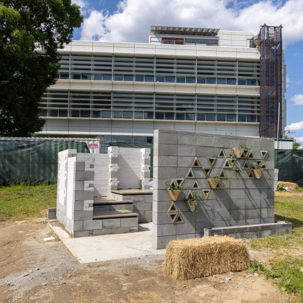 a photograph of a brick structure in a field