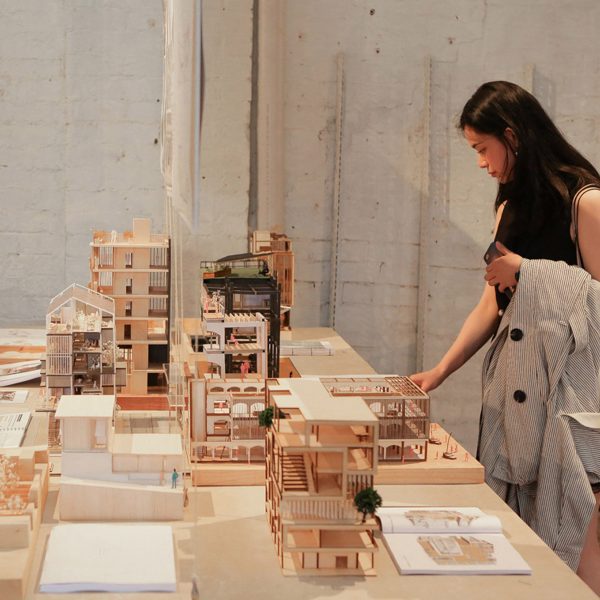 a photograph of people interacting with an exhibition