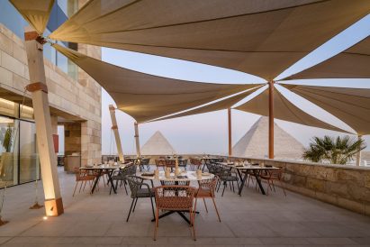 Outdoor terrace with pyramids in the background