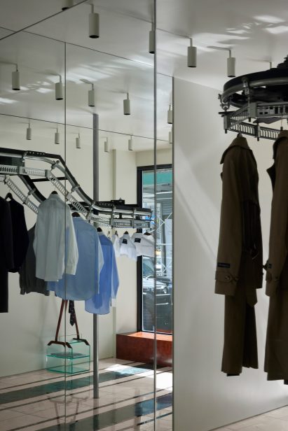 Capsule collection presented on a dry cleaner's rack