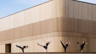 Wooden dancers on terrace of theatre