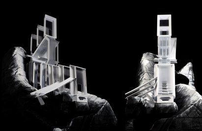 a photograph of architectural models against a black backdrop