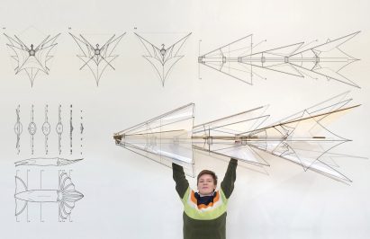 a photograph of a person holding up a design for a kite