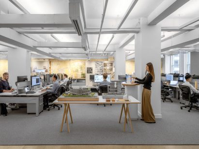 Open-plan office space with architectural models in the centre
