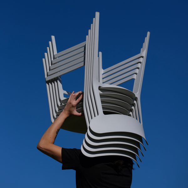 Person holding up a silver-looking chair