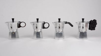 a photograph of four silver coffee pots in a line