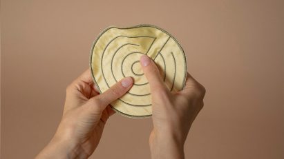 a photograph of a person holding a circle made of fabric
