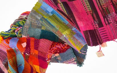 a photograph of textiles in tones of pink, green and red