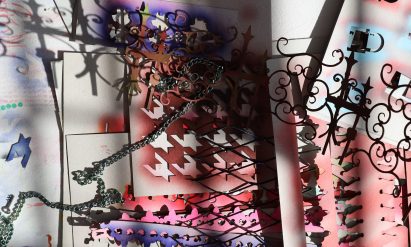 a photograph of a paper collage in tones of red, purple, black and white