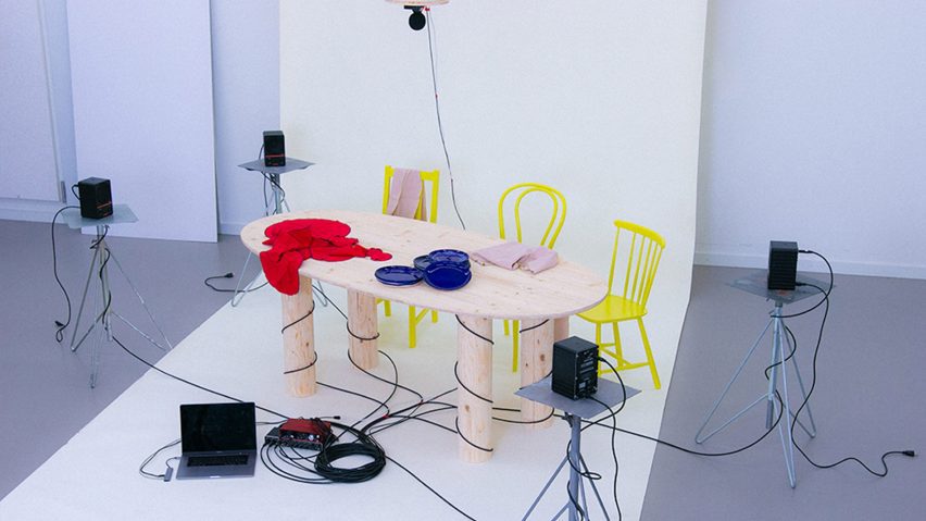 a photograph of a table and chairs with wires around it