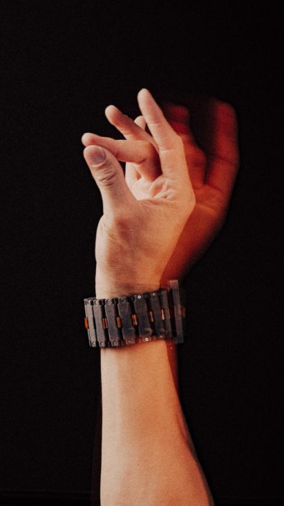 Photo of a person's hand as they test out a wearable wrist prototype while pressing their thumb against different fingertips