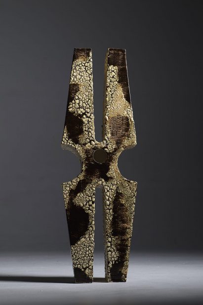 a photograph of a model in tones of brown, in an abstract shape