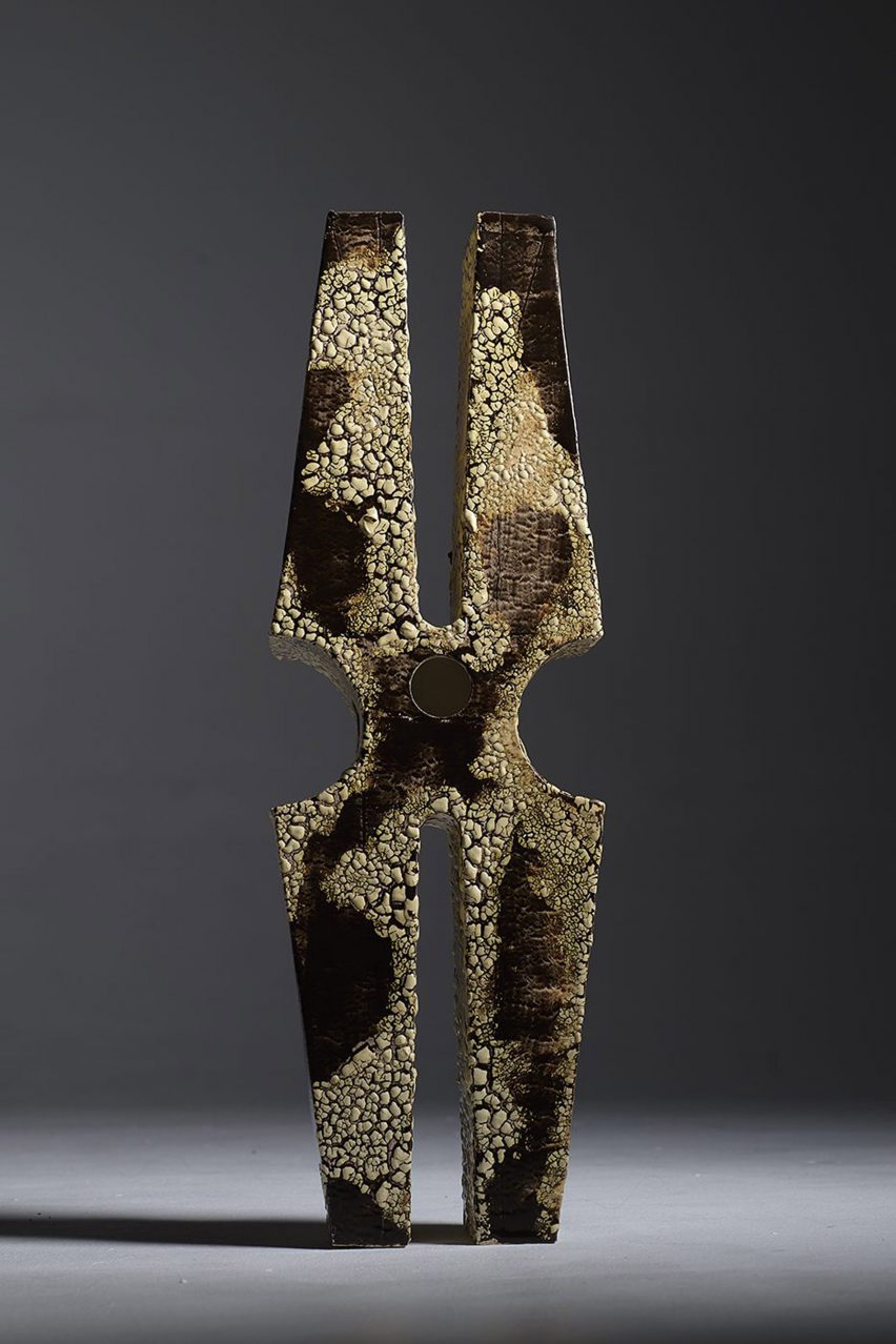a photograph of a model in tones of brown, in an abstract shape