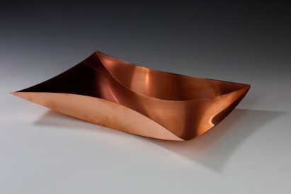 Copper-coloured tray on dark grey background