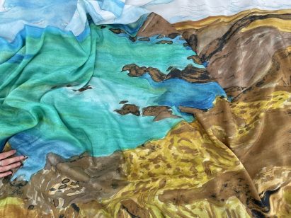 a photograph of a sheet of fabric in tones of brown, blue and turquoise