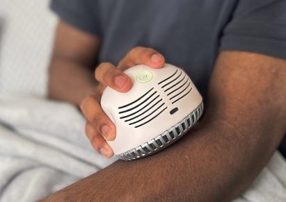 Person rubbing white plastic medical device on their arm