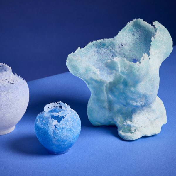 a photograph of glass sculptures in white and blue tones