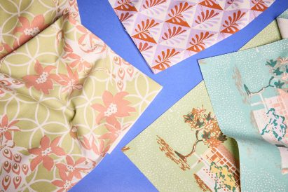 a photograph of printed fabrics against a blue backdrop