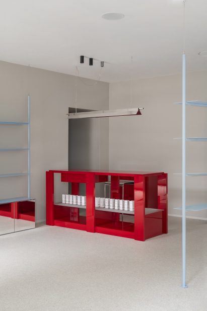 Red payment counter in minimalist shop interior